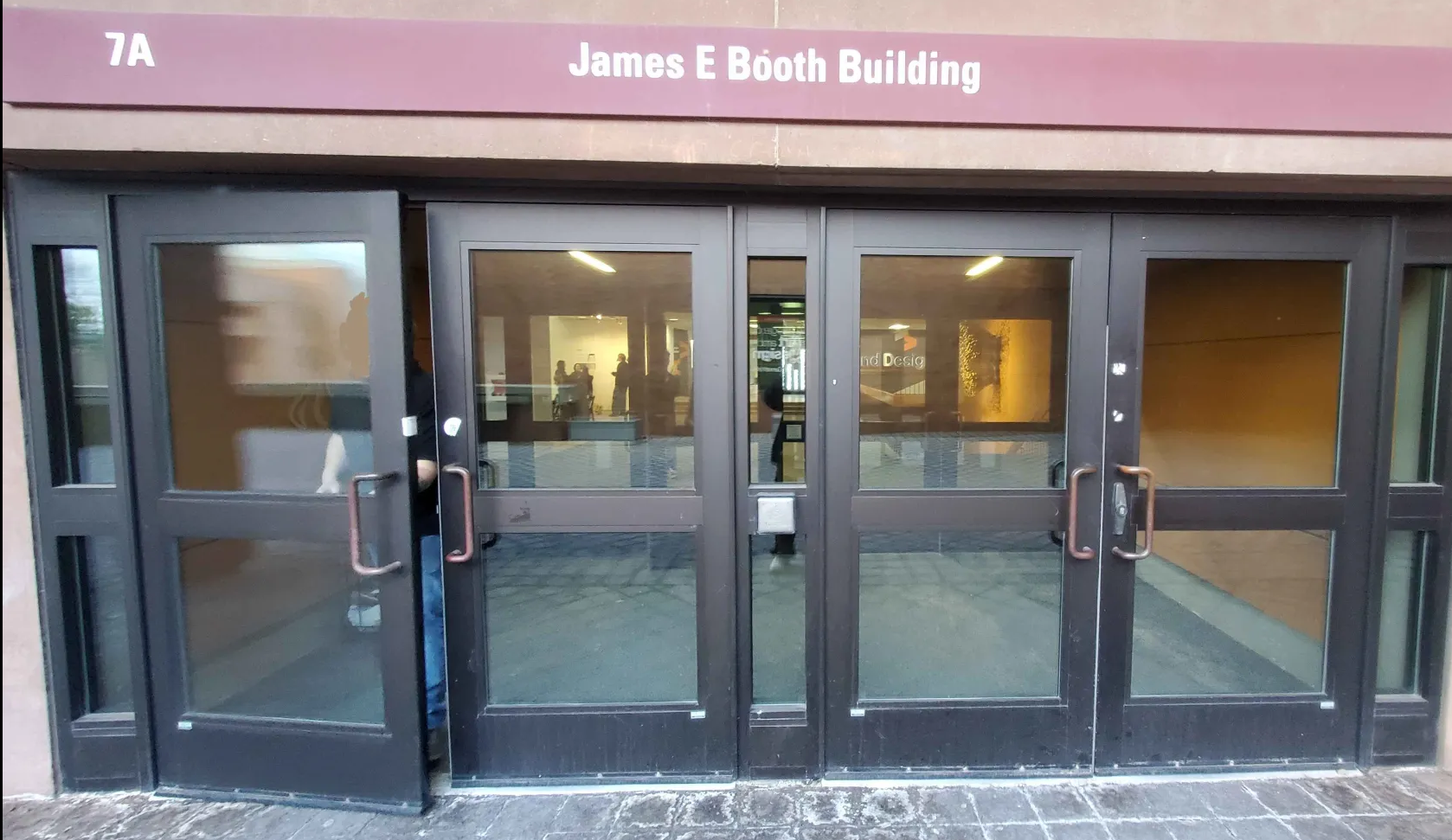 Two accessibility buttons used to swing open the main double doors at the top of the Ramp leading up to James E. Booth Hall
